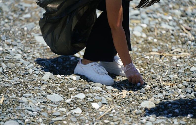 Volunteering Impact - a person's legs and feet in the sand