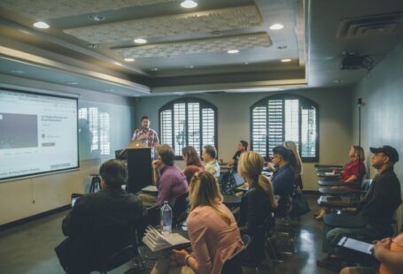 Adult Education - a group of people in a room with a projector screen