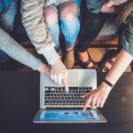 Generational Learning - three person pointing the silver laptop computer