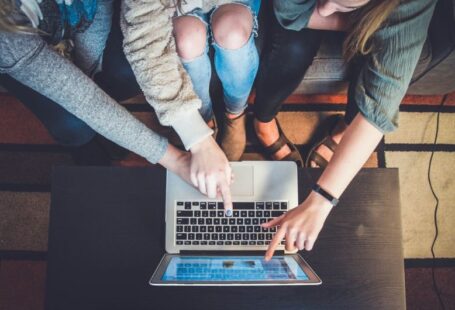 Generational Learning - three person pointing the silver laptop computer
