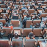 Hybrid Education - high-angle photography of group of people sitting at chairs