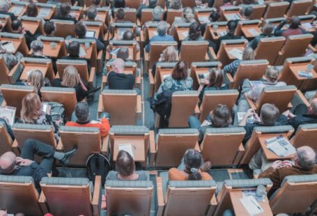 Hybrid Education - high-angle photography of group of people sitting at chairs
