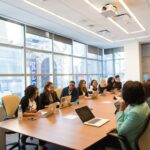 STEM Diversity - group of people sitting beside rectangular wooden table with laptops