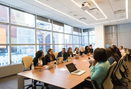 STEM Diversity - group of people sitting beside rectangular wooden table with laptops