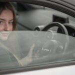 Adult Learners - a woman sitting in a car holding a steering wheel