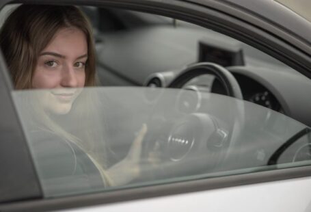 Adult Learners - a woman sitting in a car holding a steering wheel