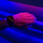 Experiential Learning - a person's hand holding onto a blue light