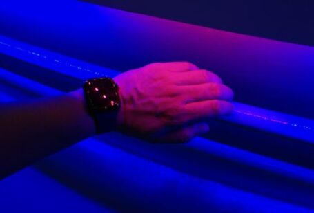 Experiential Learning - a person's hand holding onto a blue light