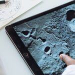 Project Learning - Crop astrophysicist exploring surface of moon while using tablet in university