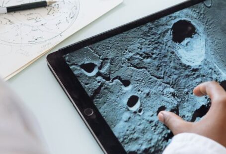 Project Learning - Crop astrophysicist exploring surface of moon while using tablet in university