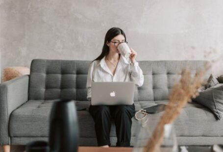 Coding Education - Woman Drinking Coffee While Working With Laptop