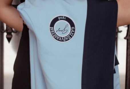 Education Trends - A woman in a black dress and blue jacket