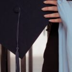 Transnational Education - A woman holding a graduation cap and gown