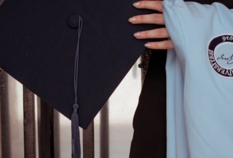 Transnational Education - A woman holding a graduation cap and gown