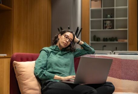 Career Flexibility - a woman sitting on a couch using a laptop computer