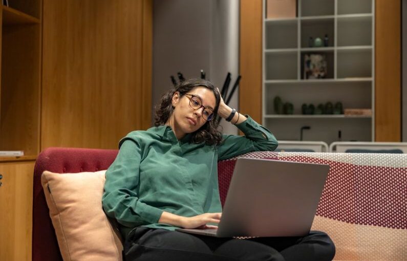 Career Flexibility - a woman sitting on a couch using a laptop computer