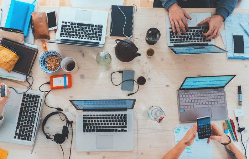 Ethical Leadership - people sitting down near table with assorted laptop computers
