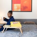 Student Entrepreneur - man sits on bed