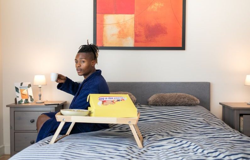 Student Entrepreneur - man sits on bed