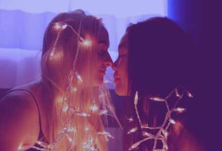 Non-traditional Student - two woman facing each other with string lights