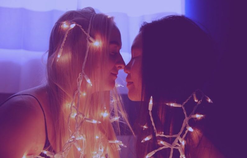 Non-traditional Student - two woman facing each other with string lights